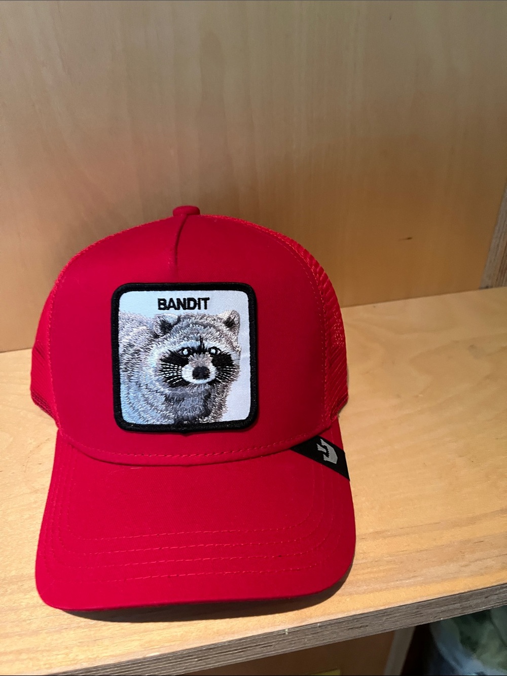 Bandit Red Trucker Hat with Raccoon Patch